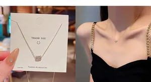 Detail of gold titanium steel necklace with zircon pendant and model wearing view