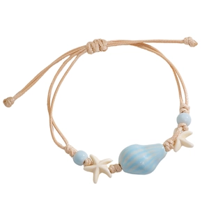 Close-up of handmade woven starfish bracelet with blue shell bead and adjustable rope