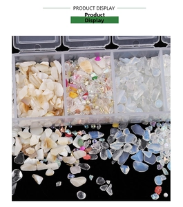 Macro shot of irregular AB iridescent glass gravel and crushed stones in 7-grid storage box