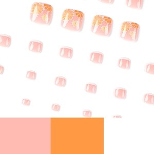Floral press-on toenails featuring pink base with orange-yellow flowers and white tips