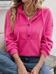 Detail of rose pink ribbed knit hoodie featuring buttoned collar and soft texture
