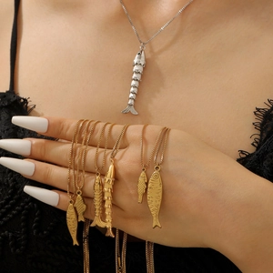 Macro shot of gold and silver koi fish necklaces with articulated metal joint details