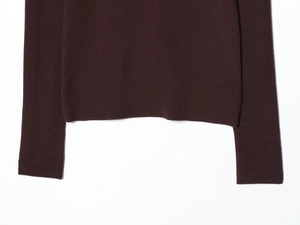 Detailed macro view of the seamless hem and cuffs on this coffee brown knit sweater