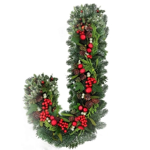J-shaped Christmas wreath with green pine needles, red berries, and natural pinecones