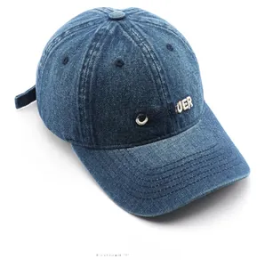Detail of CONQUER 3D white embroidery on vintage navy denim baseball cap fabric