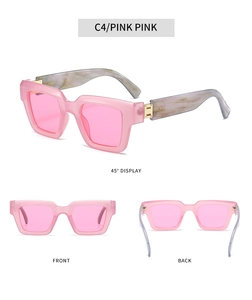 Detail of square pink sunglasses with marble pattern temples and golden hinges