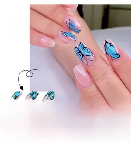 Detail of blue butterfly press on nails with glitter and pink gradient design
