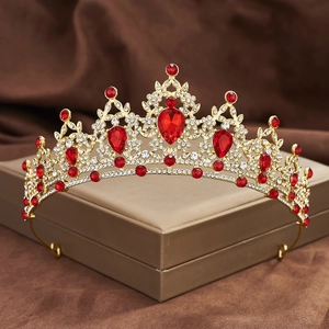 Macro detail of Baroque gold bridal crown with red teardrop rhinestones and clear crystals
