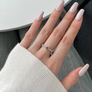 Detail of S925 silver ring featuring three green clover charms and white cubic zirconia