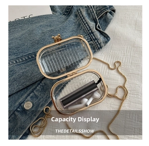 Mini transparent acrylic box bag interior showing capacity with lipstick and earphones