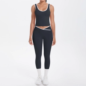 Detail of high waisted yoga leggings with cross waist design and contrast white binding