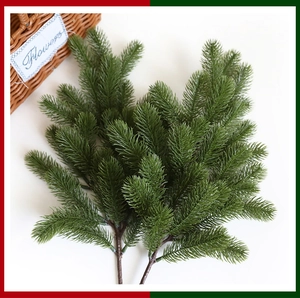 Close-up of artificial PE pine needles with realistic green branches for Christmas decor