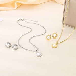 Detail of luxury gold and silver twisted chain necklaces with pearl and zircon pendants