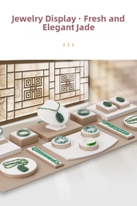 Elegant jewelry display showing jade pendants and bracelets on professional stands