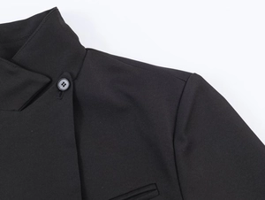 Detail of black stand collar with round button and twill texture on elegant blazer jacket