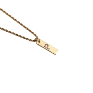 Detail view of a gold rectangular pendant featuring colorful zircons forming letter Q