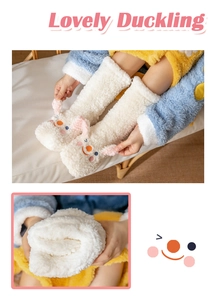 Detail of white coral fleece floor socks with cute duck patterns and soft plush texture