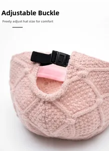 Detail of adjustable snap buckle on pink knit baseball cap for customized head fit