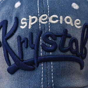 Blue denim baseball cap with Krystal embroidery and white decorative stitching details
