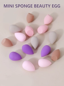 Macro view of multi-color mini makeup sponges in teardrop and slanted cut shapes
