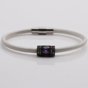 Detailed macro view of white rope bracelet with purple gem and magnetic clasp