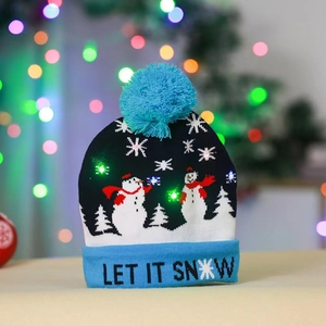 Close-up of LED glowing knitted Christmas hat with snowman pattern and blue pompom