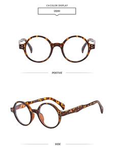 Close-up of vintage round tortoise shell eyeglass frames with double metal stud accents