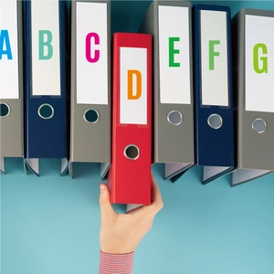 Detail of colorful waterproof letter stickers on office file folders with metal pull rings