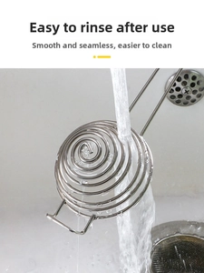 Close-up of stainless steel egg separator being rinsed under running water for easy cleaning