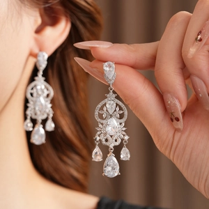 Close-up of elegant silver tassel earrings with zircon water drop and floral crystal details