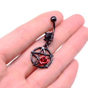 Detail of black belly ring featuring a red rose, pentagram charm and black zircon gem