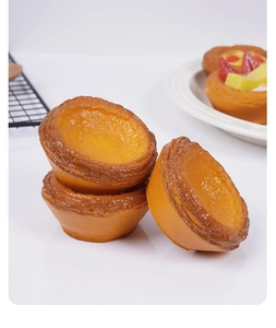Detailed macro view of realistic PU egg tart squishy toy on a cooling rack scene