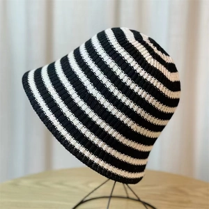 Japanese style black and white striped knitted bucket hat for women on display stand