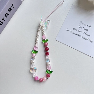 Detailed shot of pink tulip beads and iridescent butterfly pendant on phone strap