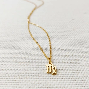 Detailed view of a golden Virgo zodiac symbol pendant on a delicate titanium steel chain