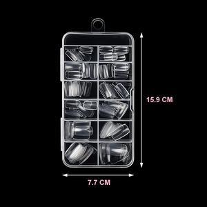 Transparent false nail tips set in a 12-grid organizer box for manicures