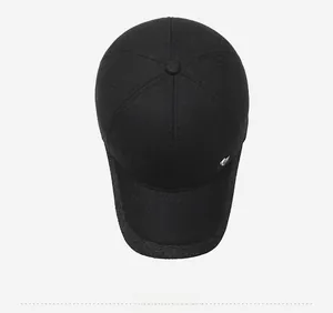 Top view of textured wool blend baseball cap in black showing crown and metal logo