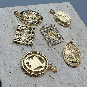 Golden Virgin Mary Guadalupe charms with colorful zircon inlays on textured stone