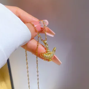 Close-up of gold magic lamp pendant necklace with pavé set white zircon crystals