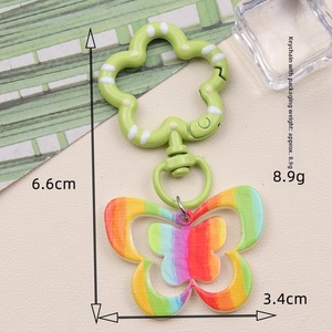 Rainbow striped butterfly acrylic keychain with green floral spring clasp and white dots