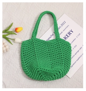 Detail of green handmade crochet cotton tote bag with intricate woven texture and patterns