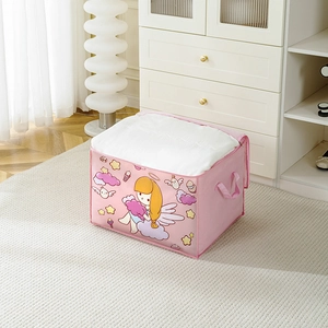 Detailed view of pink cartoon storage bag with handles holding a thick white quilt