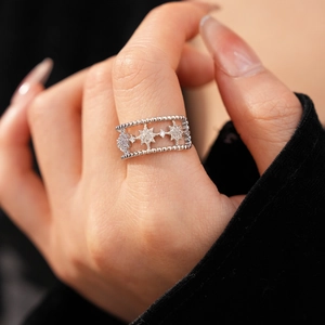 Detailed close-up of double-layer star ring with pavé-set zircons on beaded silver band