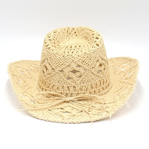 Macro detail of hand-woven star patterns on breathable hollow out straw cowboy hat