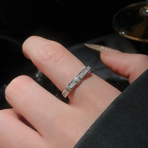 Close-up of 18k gold-plated silver ring with zircons and bow design on hand