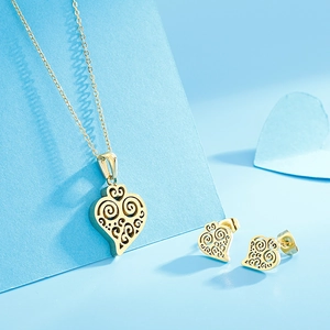 Detailed view of golden hollow heart pendant necklace and stud earrings set