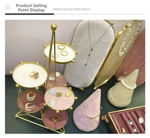 Multi-tier gold metal jewelry display stand with velvet trays for rings and earrings