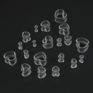 Clear acrylic heart-shaped ear gauges set in various sizes displayed on black background