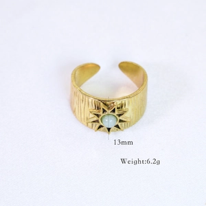 Detail view of 14k gold plated ring with sunburst design, 13mm height and 6.2g weight