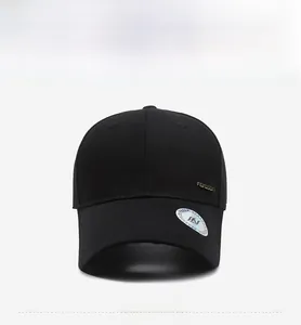 Detailed front view of a black baseball cap with golden side metal logo and curved brim